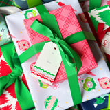 Colorful gift boxes with ribbons and tags on a patterned background